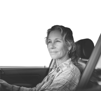 woman driving a car and smiling